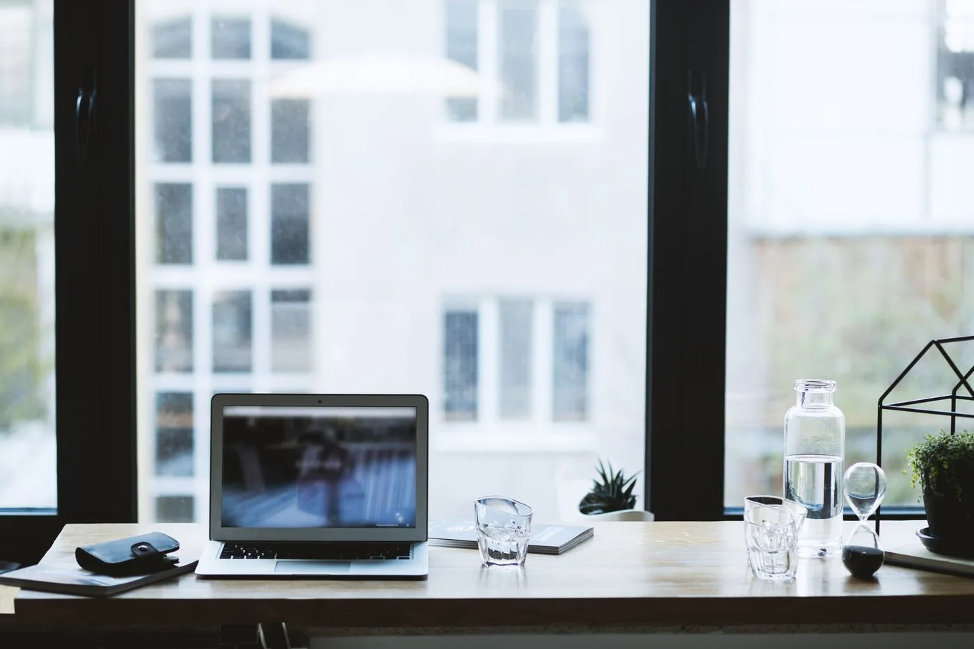 Laptop on a bright desk beside a window