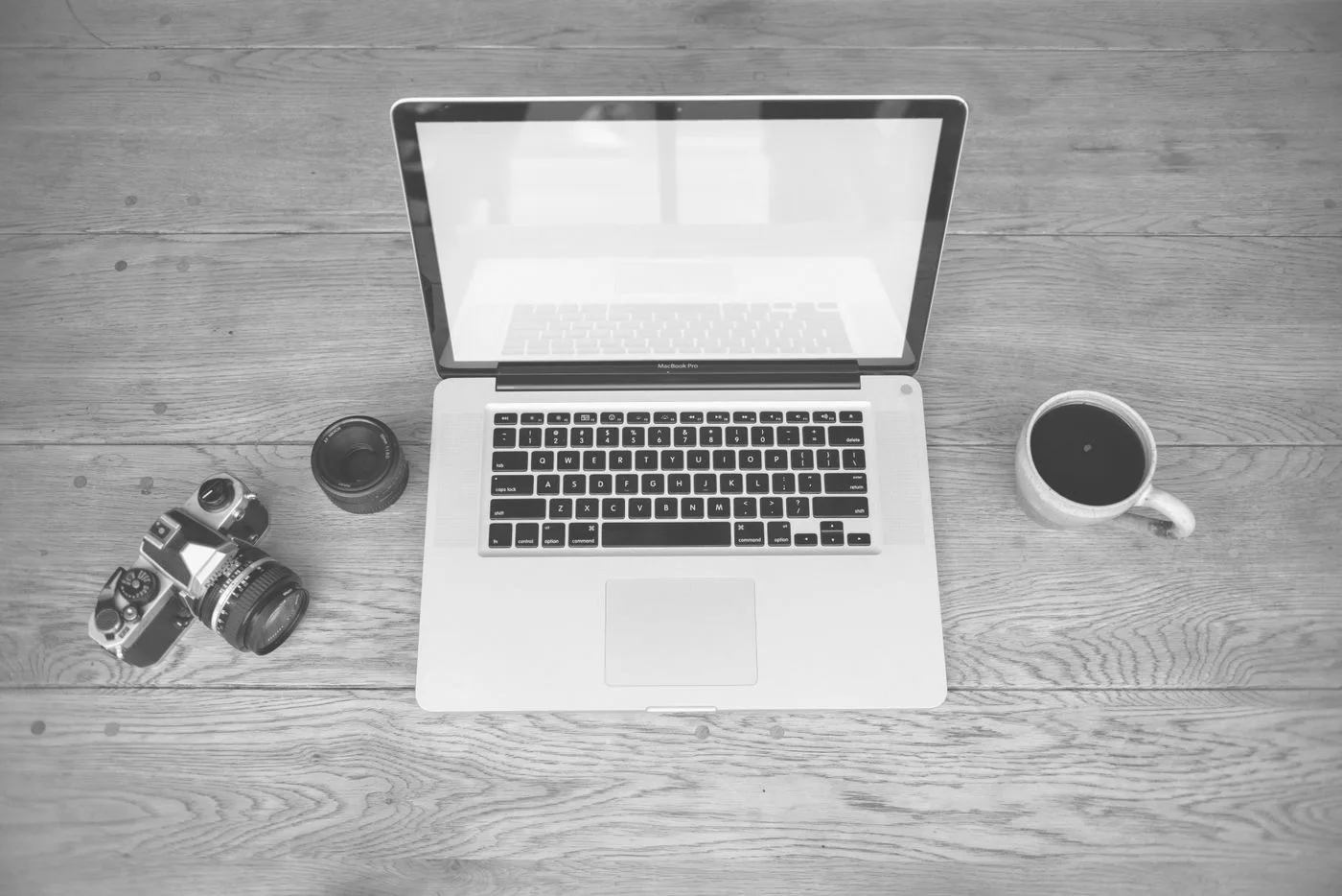 Laptop and coffee arranged on a desk