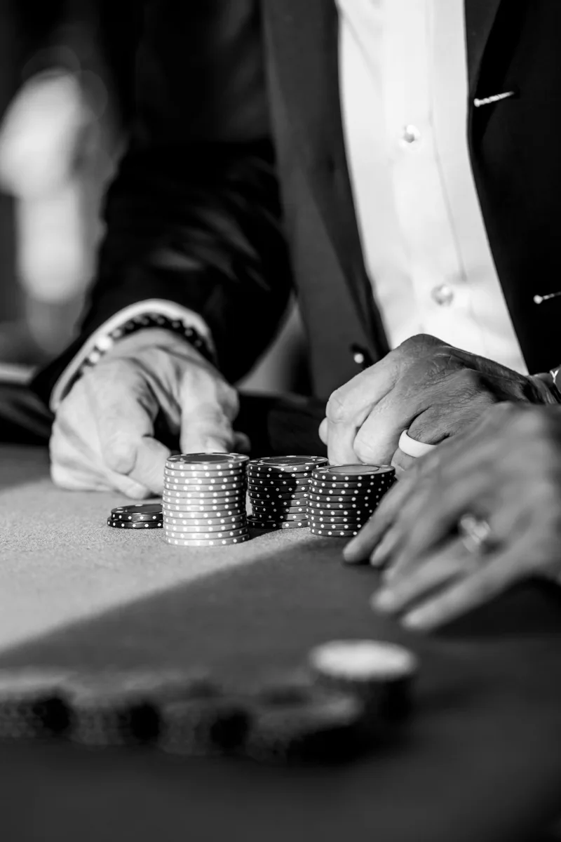 Hands arranging gaming chips in black and white