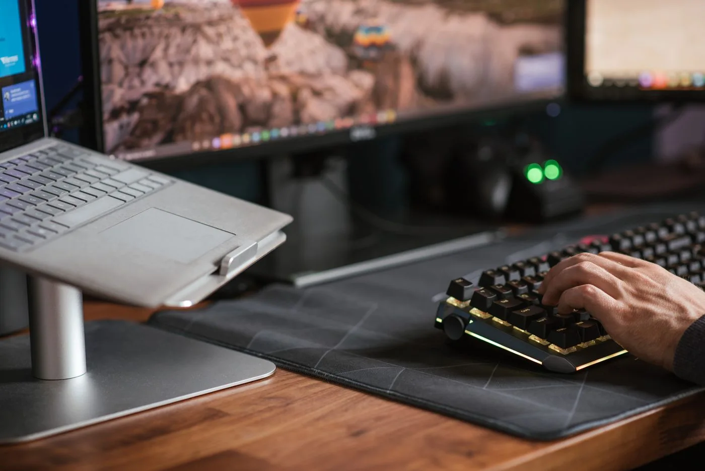 Hands at a computer keyboard and work desk