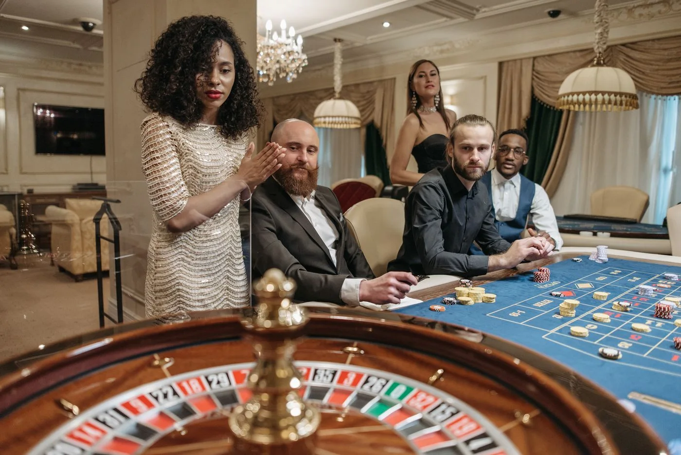 Dealer beside a roulette wheel