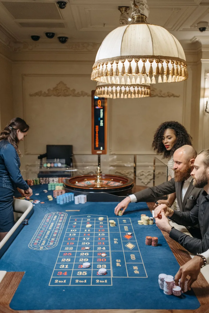 Dealer and guest beside a casino roulette table
